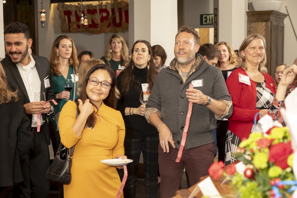 A group of people posing for a picture at the SMPS SFBAC 2019 Holiday Party
